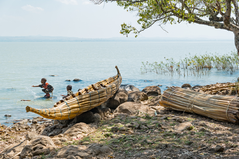 Children playing in Lake Tana near a reed canoe (not the navy’s lone boat).